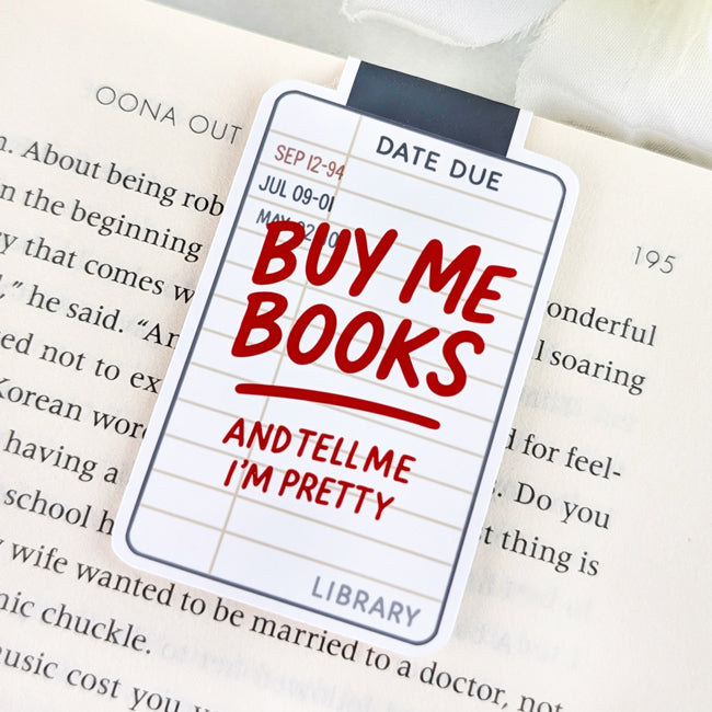 Magnetic bookmark designed like a vintage library card with the phrase “Buy Me Books and Tell Me I’m Pretty” in bold red lettering.