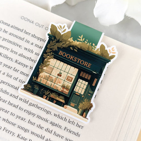 Magnetic bookmark featuring a quaint bookstore with a sign that reads "BOOKSTORE." The bookmark has a
whimsical, hand-drawn style with a vintage aesthetic.