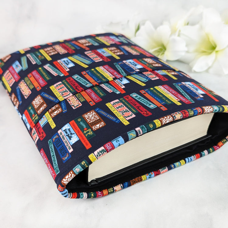 Navy blue book sleeve featuring colorful vintage-style book spines in red, yellow, and teal, creating a cozy classic library look.