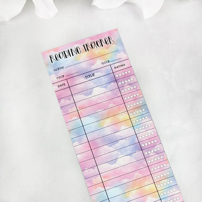 single bookmark reading tracker on a light background. bookmark has a pastel cloud background and the table to track and rate books read.