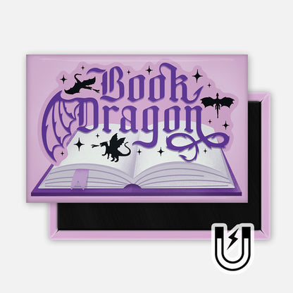 Purple rectangular magnet with the phrase “Book Dragon” in gothic lettering above an open book, surrounded by tiny dragons and sparkles.