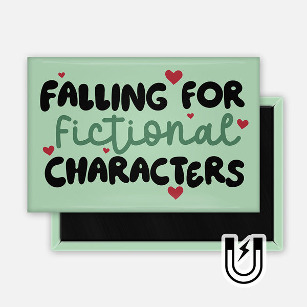 Rectangular green magnet with playful text that reads “Falling for Fictional Characters,” decorated with small red hearts.
