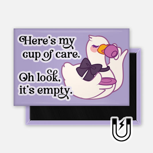 Lavender rectangular magnet featuring a white goose with a purple bow sipping from a tiny teacup beside the text “Here’s my cup of care. Oh look, it’s empty.”