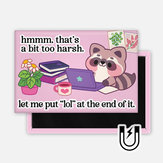 Pink rectangular magnet featuring a cute raccoon typing on a laptop with books, plants, and a mug nearby. The text reads, “hmmm, that’s a bit too harsh. let me put ‘lol’ at the end of it.”