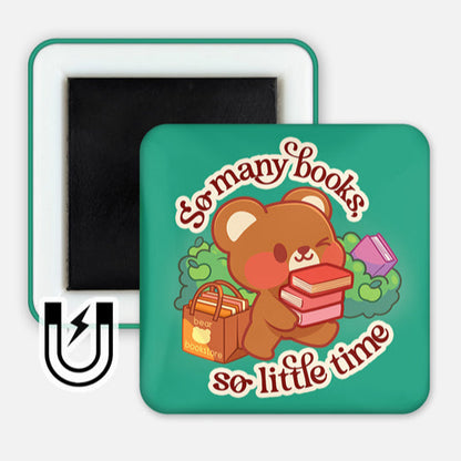 A square magnet featuring a cute brown bear holding a stack of colorful books with a happy expression. Beside the bear is a shopping bag labeled "bear bookstore" filled with more books. The background is teal with leafy green bushes, and the text "So many books, so little time" is written in a playful red font around the bear. A small magnet icon in the corner indicates the product type.